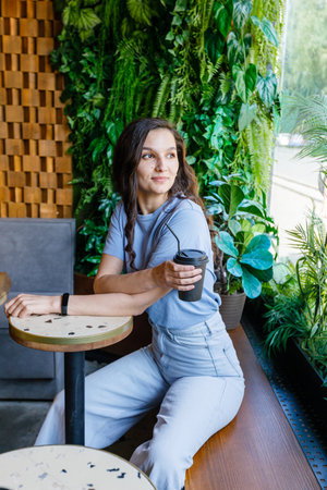 Portrait of beautiful woman having cup of coffee in cafeの写真素材