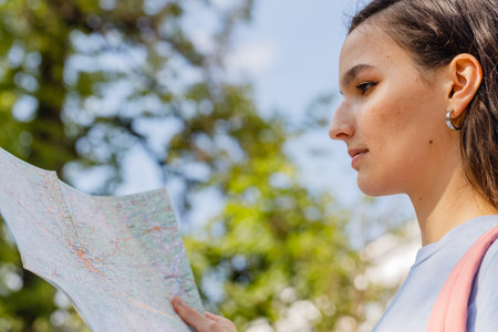 travel guide, tourism in Europe, woman tourist with a map on the streetの写真素材