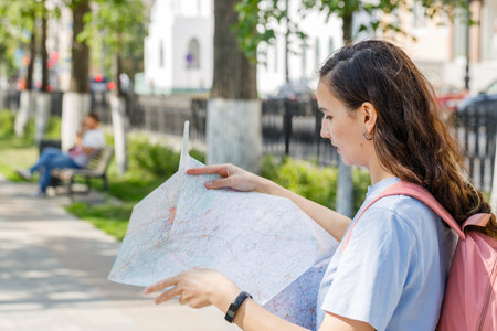 travel guide, tourism in Europe, woman tourist with a map on the street