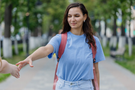 young girl extends her hand to a meeting, and offers friendshipの写真素材