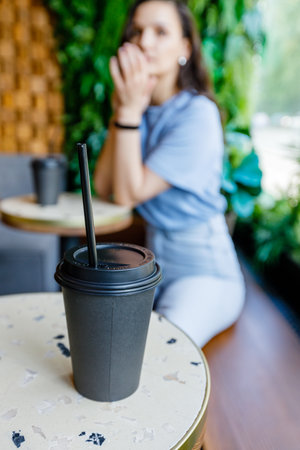 Portrait of beautiful woman having cup of coffee in cafeの写真素材