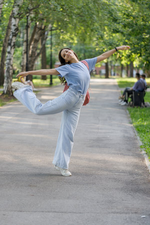 funky woman dancing alone in the street. Attractive caucasian woman dancing smiling at the cameraの写真素材