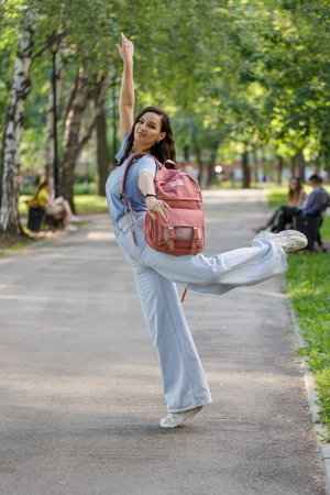 funky woman dancing alone in the street. Attractive caucasian woman dancing smiling at the cameraの写真素材
