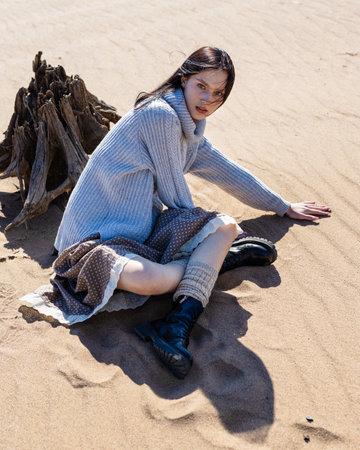 Traveler young woman is standing on the sand. Without water, sea or riverの写真素材