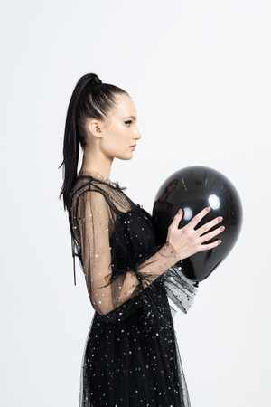 Young fashionable pretty woman with monochrome black balloonsの写真素材