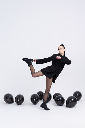 Beautiful young girl with stilish black balloons, Joyful model. Fashion beauty SPA conceptの写真素材