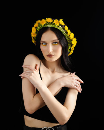 Young woman in national clothes wearing yellow dandelion wreathの写真素材