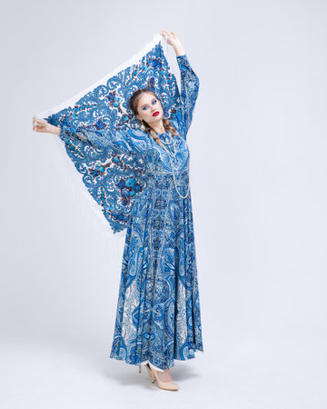 beautiful young woman in nice spring folk dress, posing. Fashion photo, folklore style. Braid hair styleの写真素材