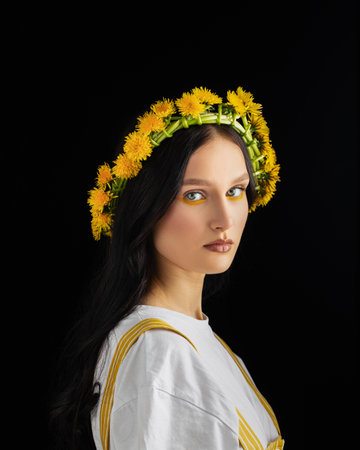 Closeup portrait Young woman in wreath from yellow dandelions.の写真素材