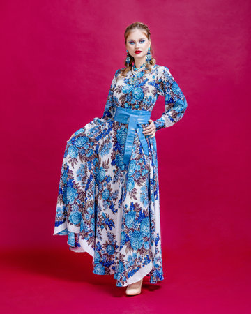 woman wear stylized national embroidered dress and handkerchief on head. Fashion concept, national folk and cultureの写真素材