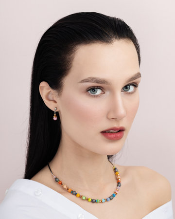 Closeup portrait of beautiful brunette model girl with long straight hair and bright red lips. Concept of beauty, fashion, style. Model with well-kept skin and bare shouldersの写真素材