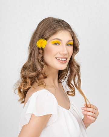 Happy smiling woman with yellow flowers in their hands - Closeup of yellow flowers, on focusの写真素材