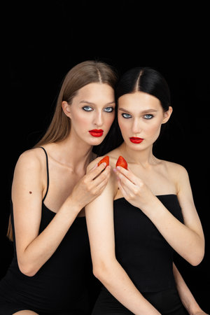 Beautyful girl's couple hold and eat strawberry. love story. Healthy eating concept. Dieting. joy conceptの写真素材
