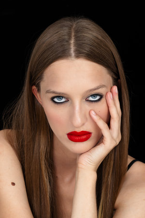 Beautiful woman portrait, beauty on dark background, red lipsの写真素材