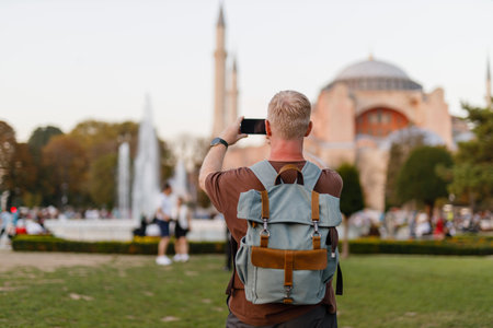 tourist takes photos of the mosque on his phone