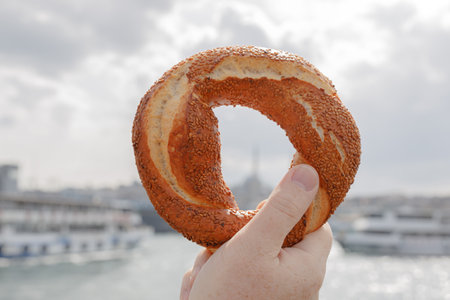 Simit - traditional Turkish bread in the hands of a travelerの写真素材