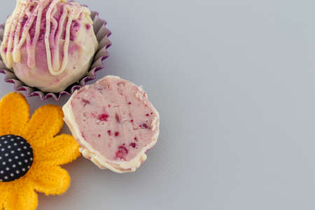 Chocolate candy handmade and homemade on grey background with yellow flowerの写真素材