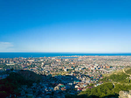 Landscape made from the mountain of Makhachkala city in Russia with a clear blue sky above the ocean without clouds.の写真素材