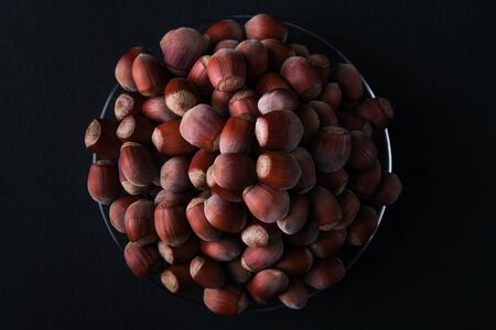 Hazelnut isolated on black background. Set or collection. Stack of hazelnuts. Hazelnut backgroundの写真素材