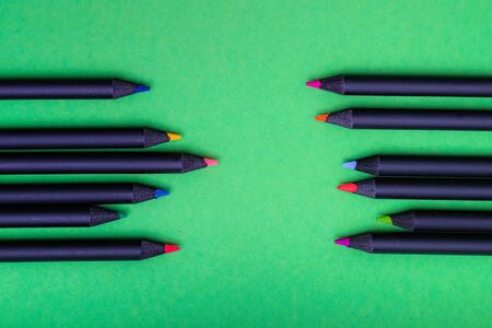Color pencils of various color on a green backgroundの写真素材