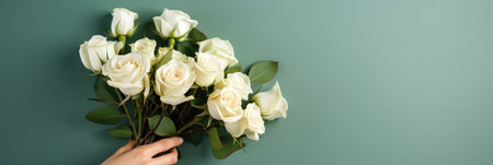 cropped view of woman holding bouquet of white roses on greenの素材
