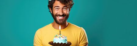 happy man with birthday cake on turquoise background, panoramic shotの素材