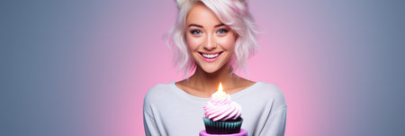 Beautiful blonde woman with birthday cupcake on gradient background. Copy space.の素材