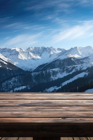 A dark wood table on the cabin deck offers perfect views of a snow-covered forest, icy lake, and snow-capped peaks.の素材