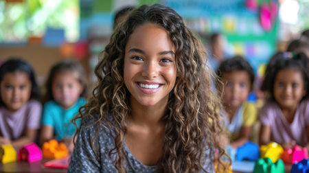 Energetic young teacher in a lively classroom, highlighting the impact and joy of teaching.の素材