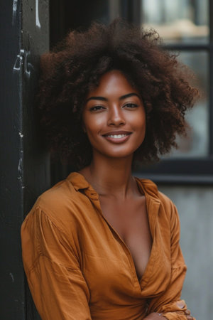 Urban Contentment: Candid Shot of Woman with Natural Afro, Casual Blouse, Relaxed Posture, Genuine Smile, Soft Background Blurring Cityscapeの素材