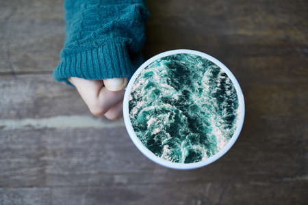 Cup of coffee in the ocean.の写真素材