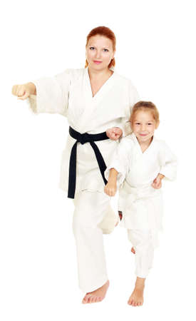 Mom and daughter with a smile in a kimono hit a hand on a white backgroundの写真素材