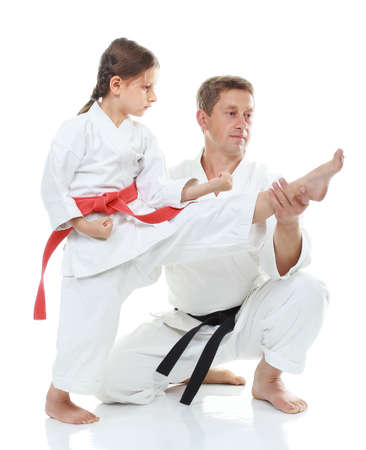 Girl learns to hit a kick dad helpsの写真素材