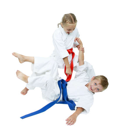 Girl in a kimono throws the boy in a kimono isolatedの写真素材