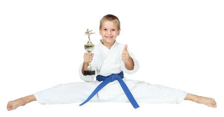 The sportsman in a kimono sits on a twine with an award in hand, and shows the finger isolatedの写真素材