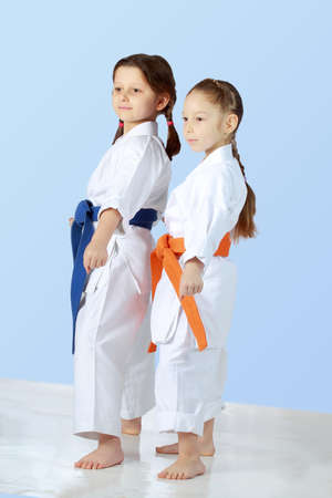 Girls athletes with orange and blue belt stand in rackの写真素材