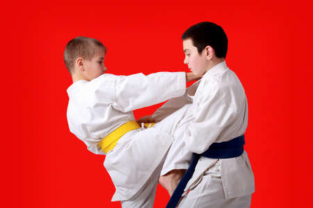 An athlete with a yellow belt beat kneeing athlete with a blue beltの写真素材