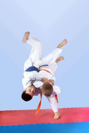 On a light background athletes is doing judo throwsの写真素材