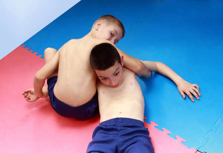 Reception retention are training boys in shorts on the matの写真素材