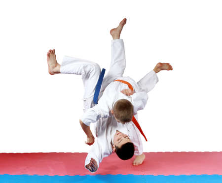 Active small athletes in kimono make tall throwの写真素材