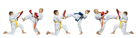 On the white background sportsmen are beating blows leg forward on simulator collageの写真素材