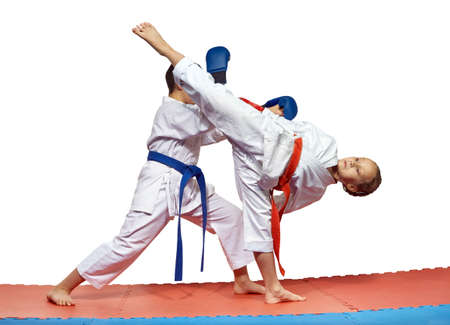 Blow Ura mavashi geri and protection from him are training athletes in karategiの写真素材