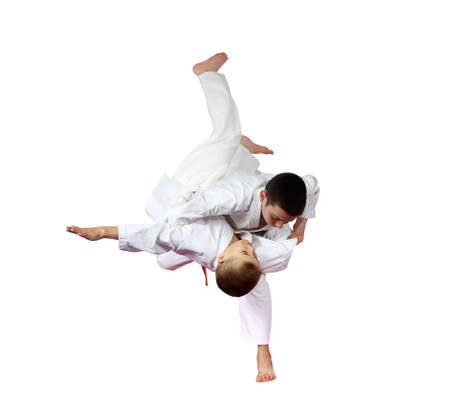 Two boys athlete are doing judo throws isolated