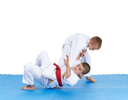Two athletes in judogi are training throwsの写真素材