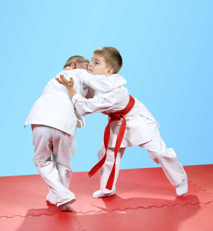 With a white and red belt children trained judo techniquesの写真素材