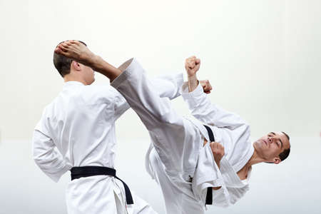 Collage of a punch arm and a kick leg in the performance of athletes