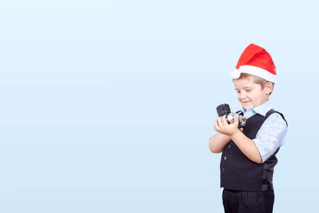 Little photographer in hat of Santa Clausの写真素材
