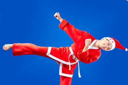 Girl dressed as Santa Claus hits a kick legの写真素材