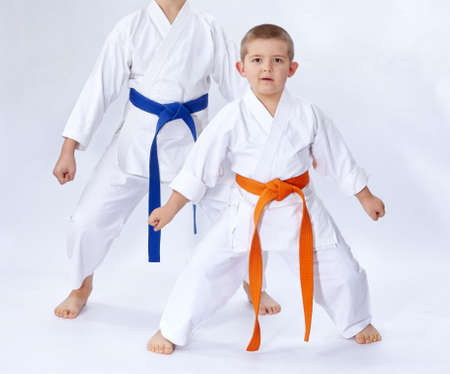 Two athletes in karategi stand in the rack karate on a white backgroundの写真素材