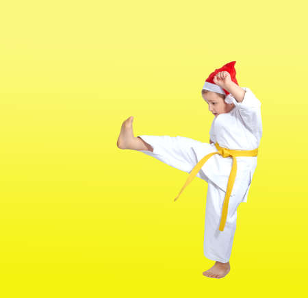 On a yellow background boy beats kickingの写真素材